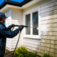 Professional Water Blasting Auckland service cleaning a home's exterior before painting